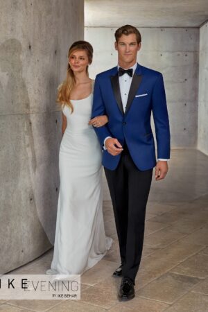Two models pose as a man and woman on a stroll, the man is wearing the Wainscott blue peak tuxedo jacket rental from TuxKit.