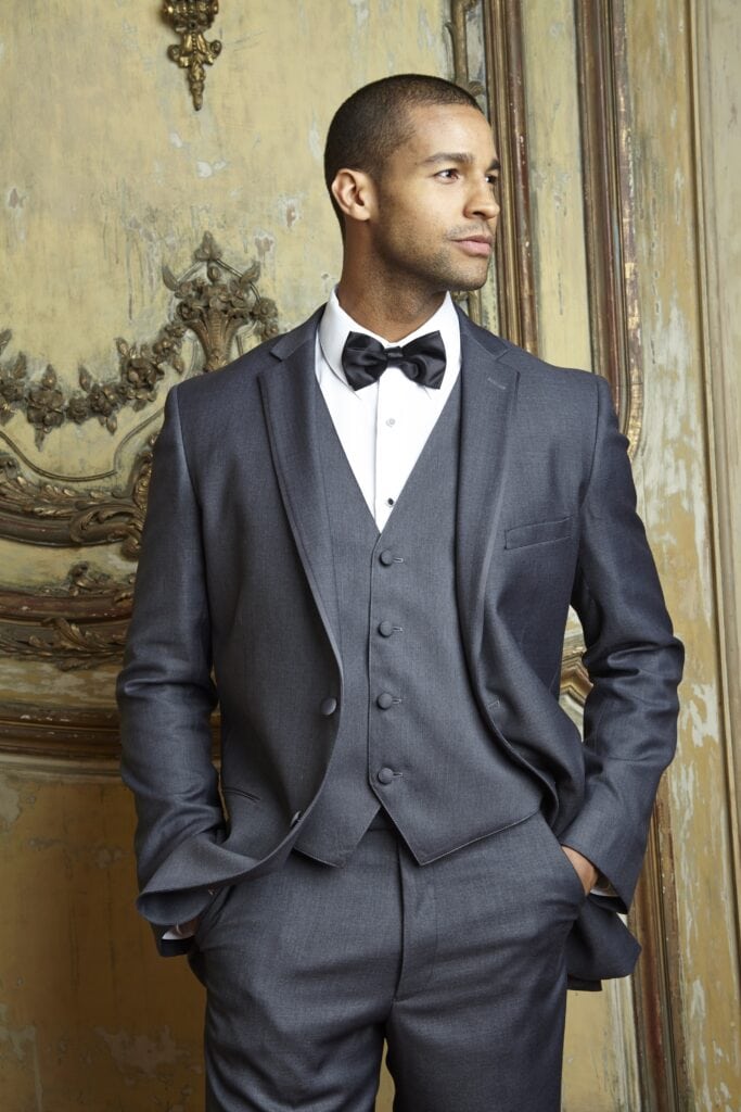 A steel grey tuxedo, shown on a model in a music room